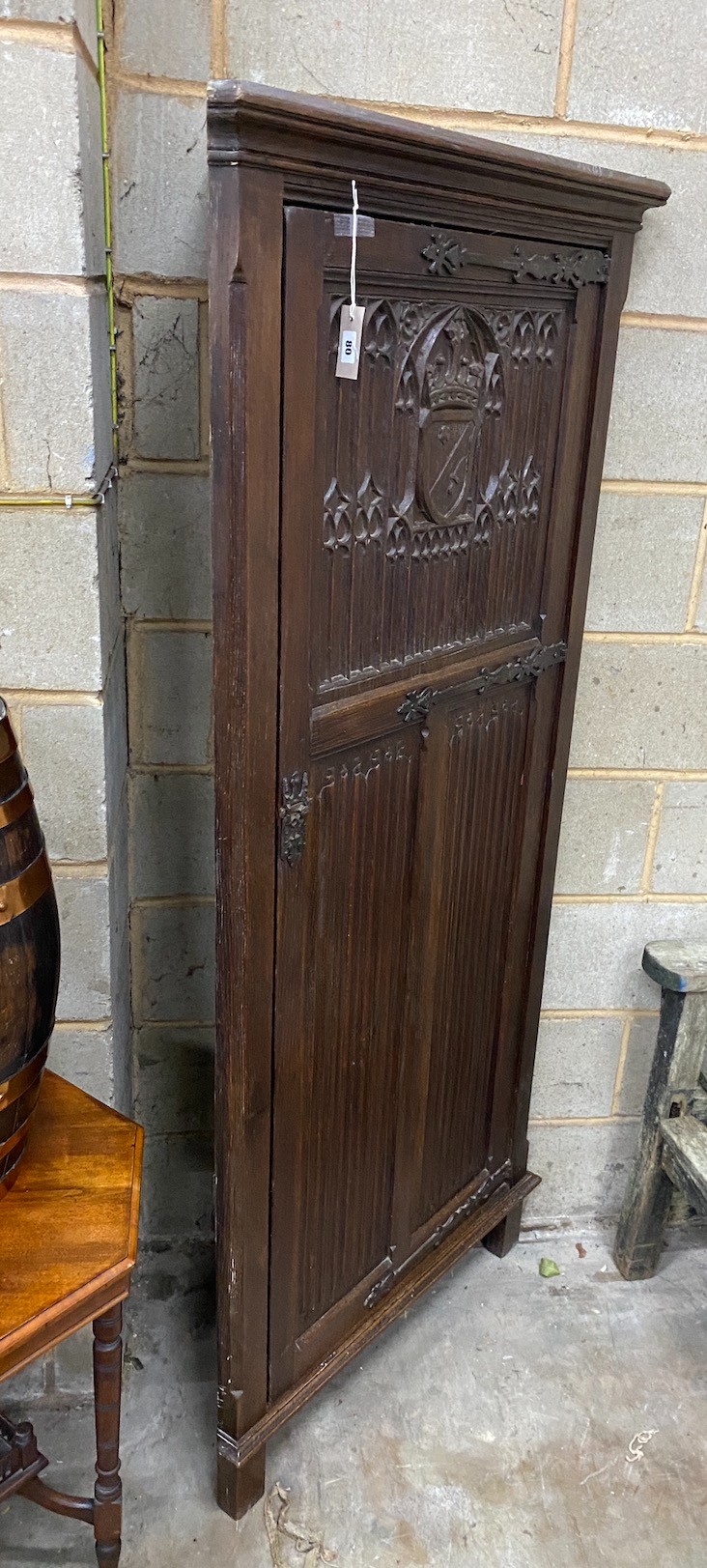 A 17th century style oak linenfold moulded standing corner cabinet, width 83cm, depth 45cm, height 180cm